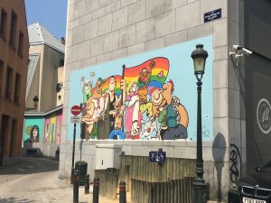 cartoon, colorful pride mural on the side of a building in Amsterdam