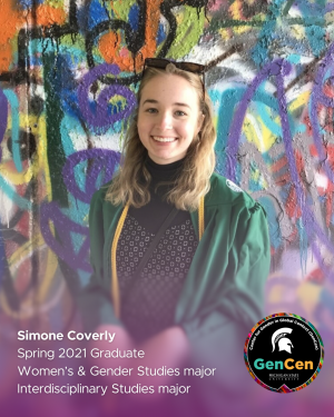 Simone Coverly wearing a black dress and green graduation gown in front of a spray-painted wall