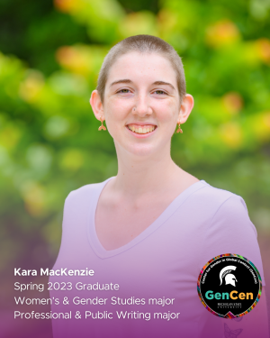 Kara MacKenzie smiling in a white shirt and gold earrings